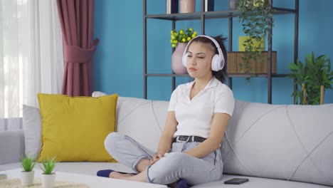 Young-woman-listening-to-music-with-headphones-is-unhappy-and-sad.